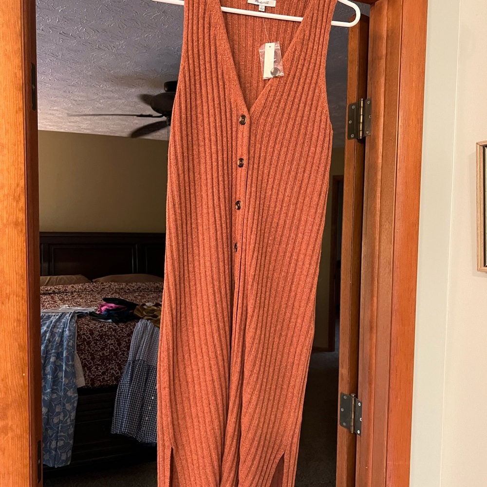 Get ready for fall with this rust-colored sleeveless sweater dress.